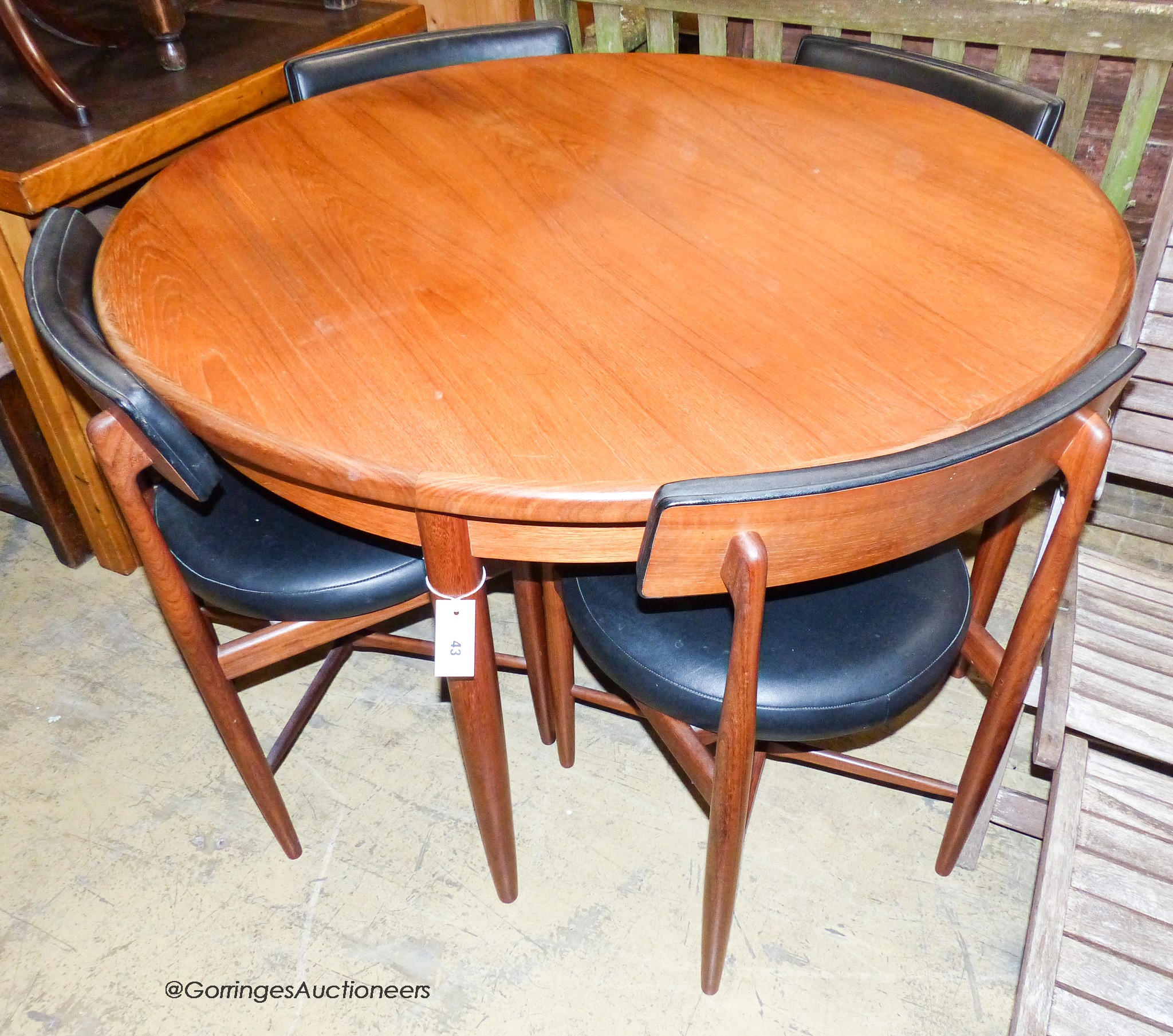 A teak and leatherette Fresco dining suite by Wilkins for G Plan, comprising circular extending dining table, 120cm diameter (166cm extended), height 73cm and four chairs